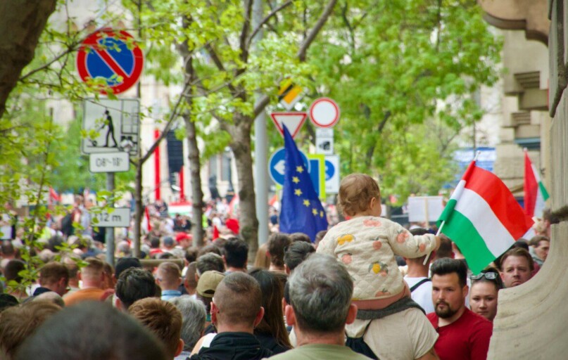 a crowd of people walking down a street