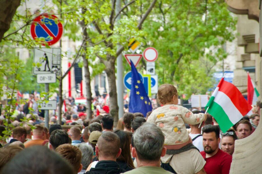 a crowd of people walking down a street