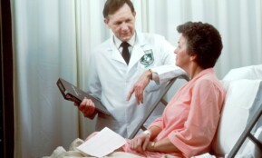 man in white button up shirt holding black tablet computer