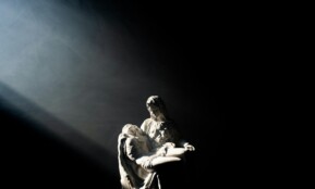 man in white and black jacket and pants sitting on black surface