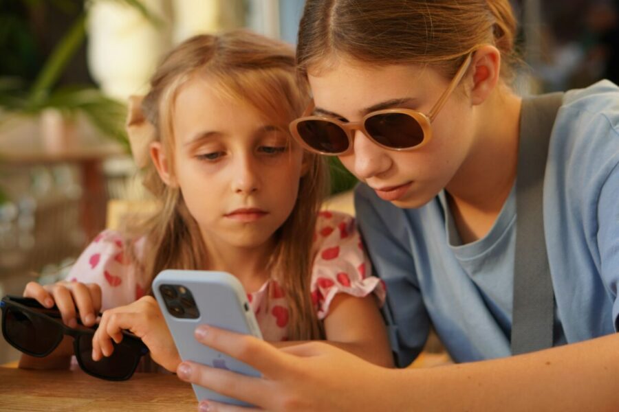 A woman and a girl looking at a cell phone