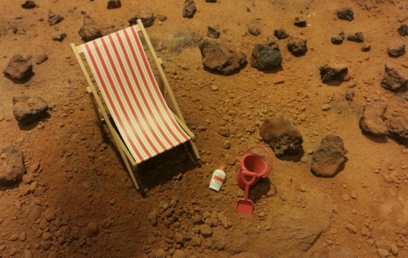 red and white striped folding bed on brown sand