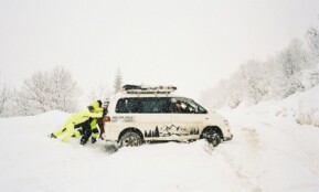 A couple of people that are standing in the snow