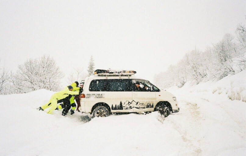 A couple of people that are standing in the snow