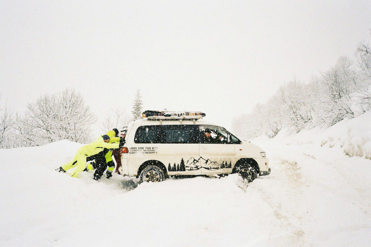 A couple of people that are standing in the snow