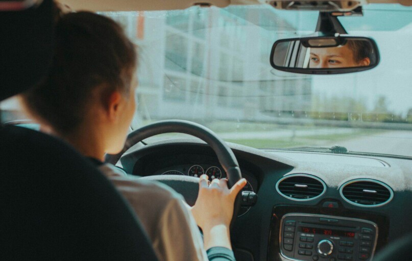 man in black shirt driving car