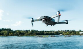 black DJI Mavi quadcopter near body of water