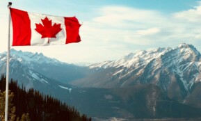 red and white flag on top of the mountain