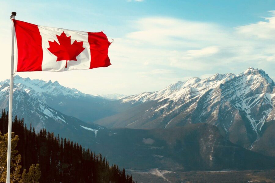 red and white flag on top of the mountain