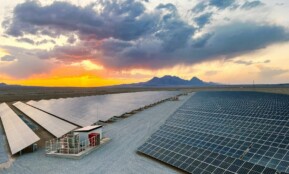 a large array of solar panels in a desert