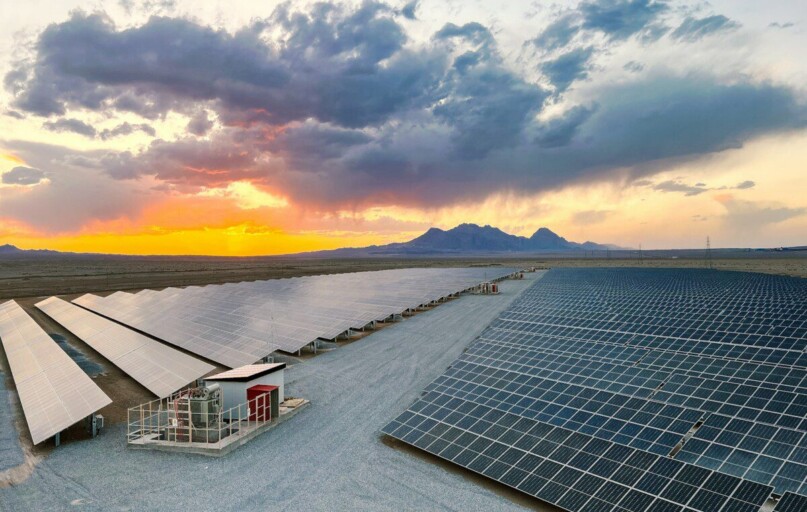 a large array of solar panels in a desert
