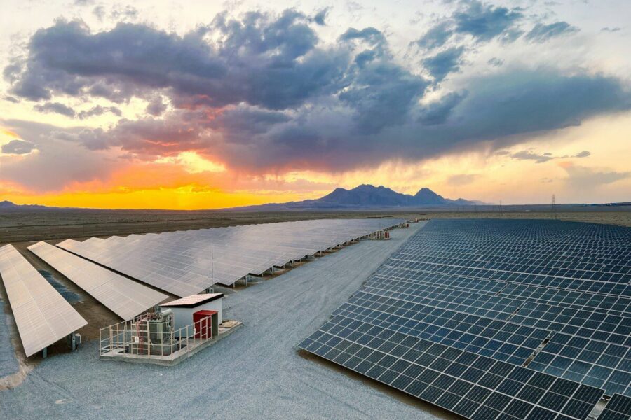 a large array of solar panels in a desert