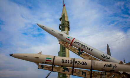 A group of fighter jets sitting on top of each other
