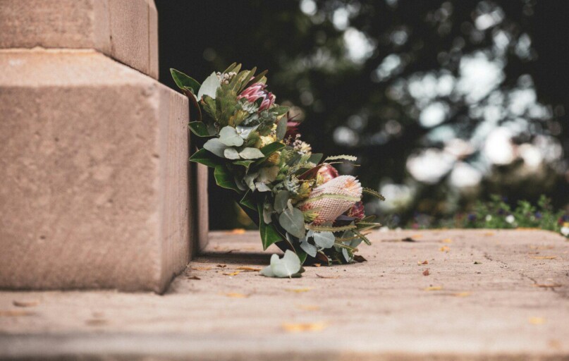 pink and green flower bouquet on brown concrete wall