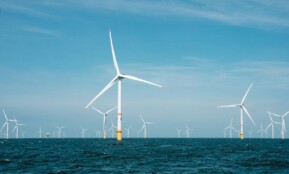 a group of wind turbines in the ocean