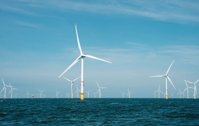 a group of wind turbines in the ocean