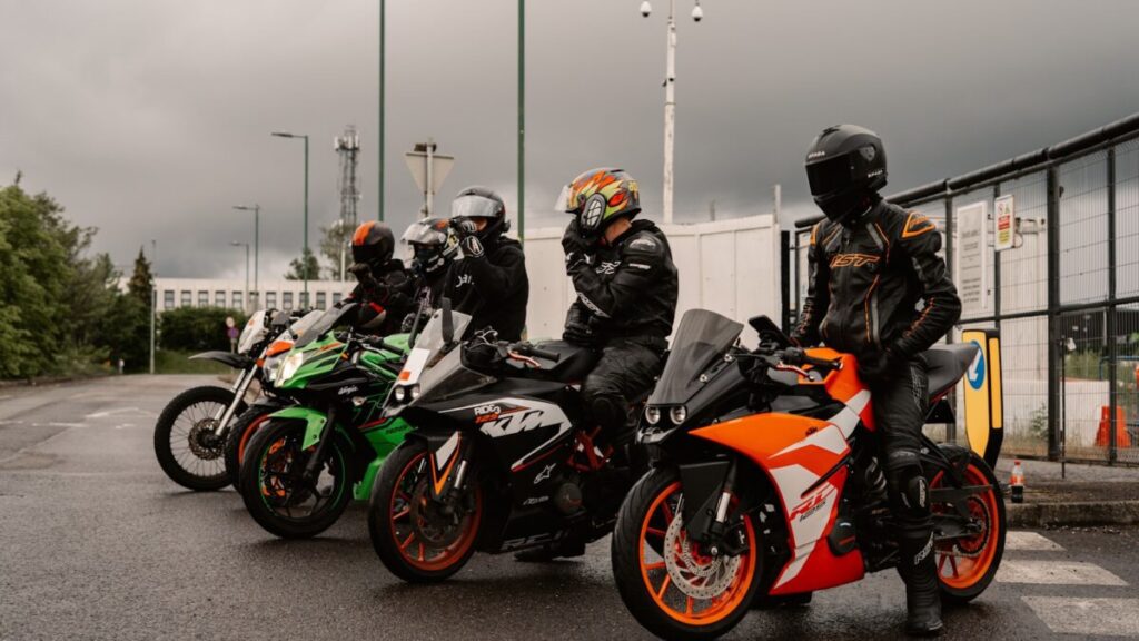 Motorcyclists on their bikes prepare to ride.