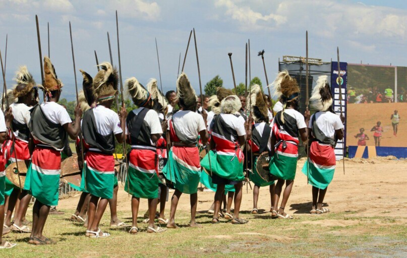 Warriors in traditional attire with spears