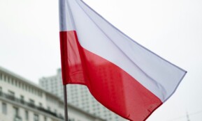 The polish flag waves in the breeze.