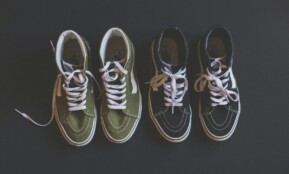 two pairs of black green-and-black Vans Sk8-Hi sneakers