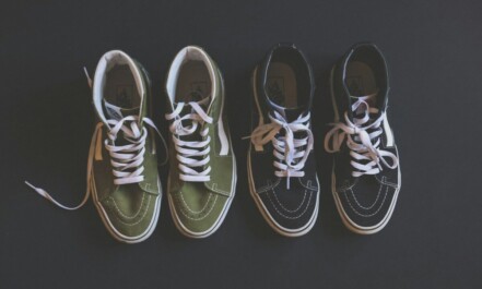 two pairs of black green-and-black Vans Sk8-Hi sneakers