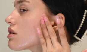 a woman with her hand on her face