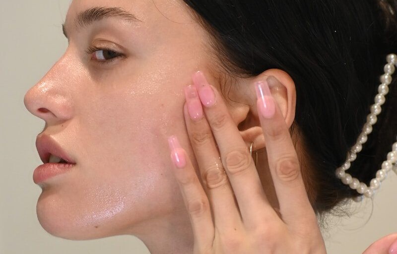 a woman with her hand on her face