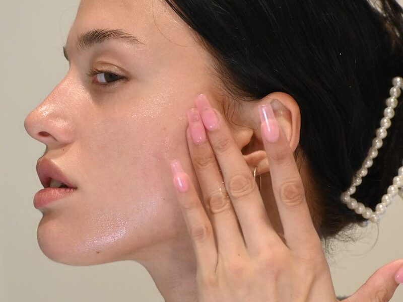 a woman with her hand on her face