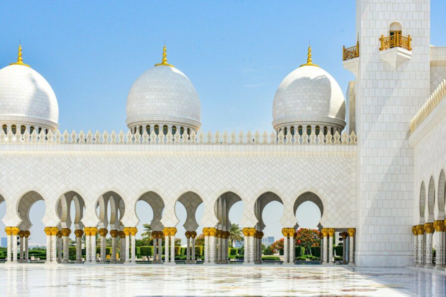 A large white building with many arches and domes