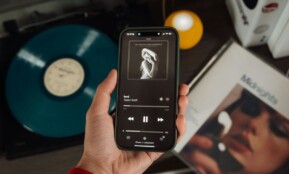 a person holding a cell phone in their hand