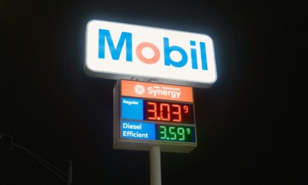Mobil gas station sign with fuel prices at night
