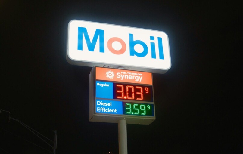 Mobil gas station sign with fuel prices at night