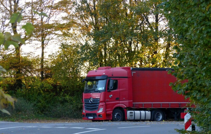 a red truck is parked on the side of the road