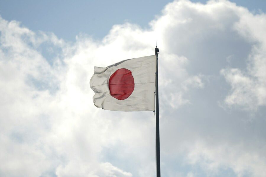 a white and red flag flying in the sky
