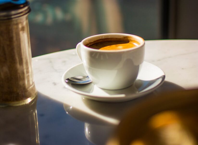 white ceramic cup on saucer