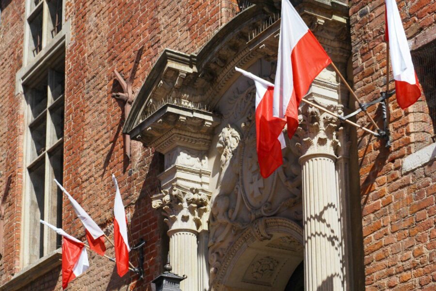 a building with flags hanging from the side of it