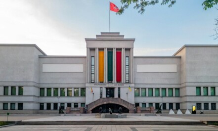 A stately building with a flag flying.