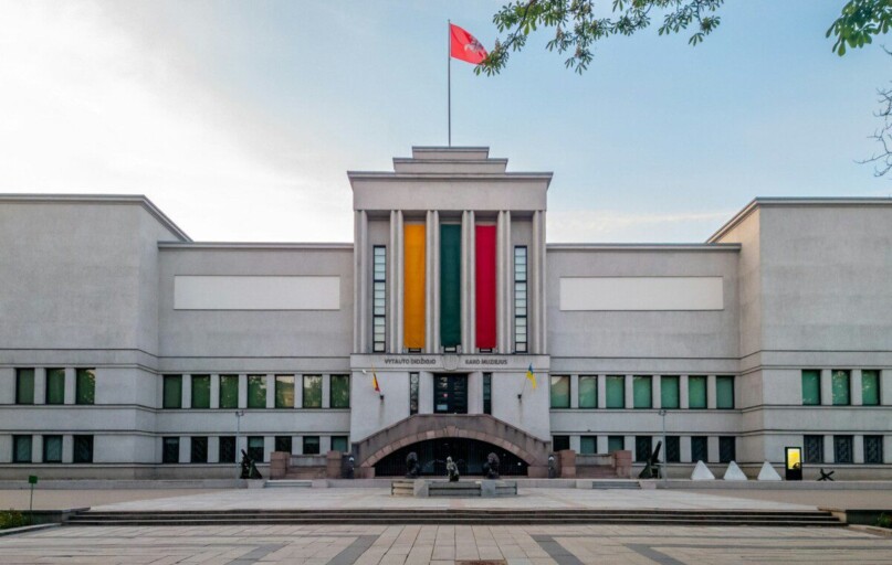 A stately building with a flag flying.