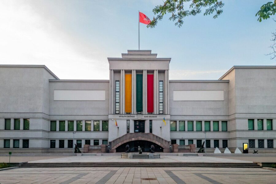 A stately building with a flag flying.