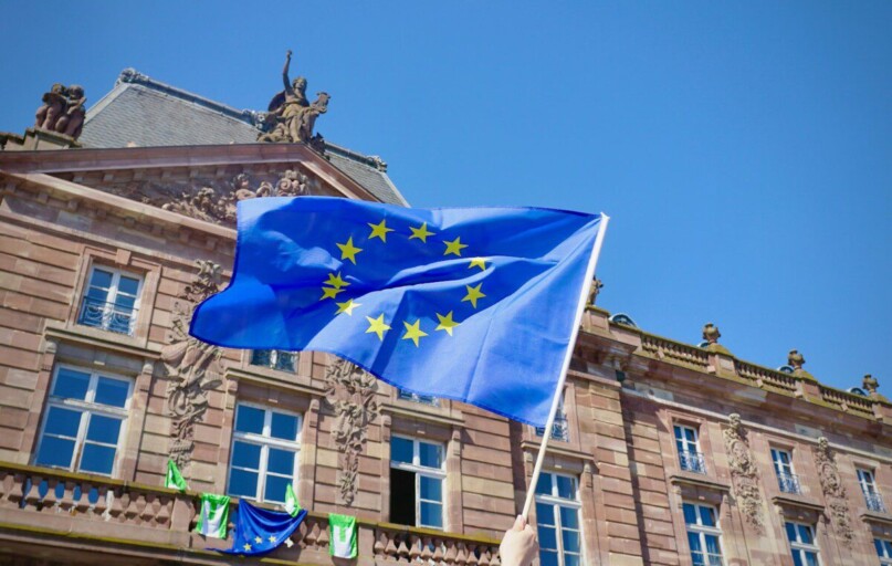 a flag on a pole in front of a building