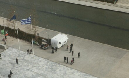 a group of people standing around a white truck
