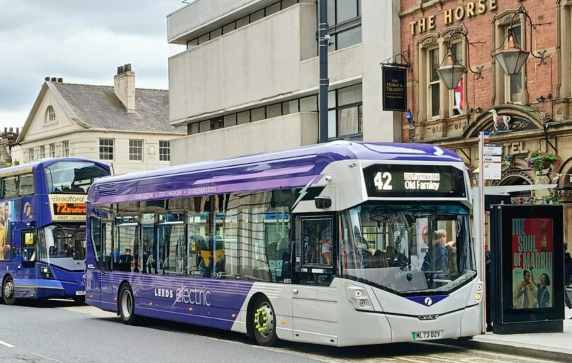 A couple of buses that are sitting in the street