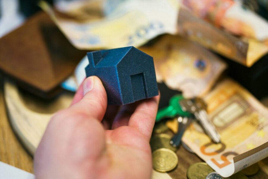 Buying a house with money, keys, and coins.