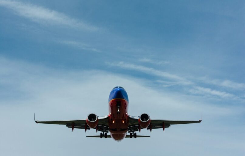 blue and red airplane on sky