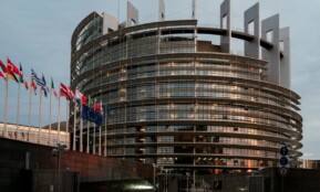 a large building with a lot of flags in front of it