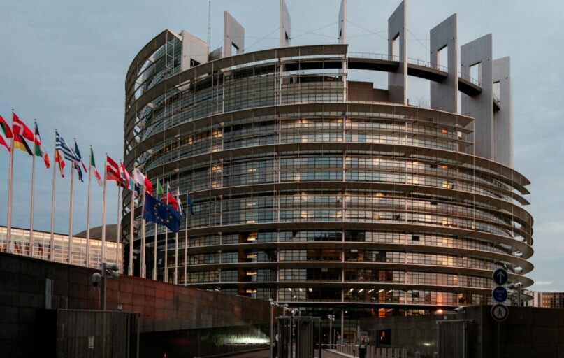 a large building with a lot of flags in front of it