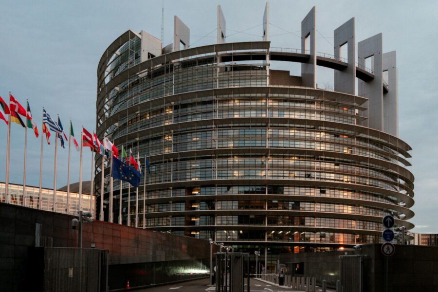 a large building with a lot of flags in front of it