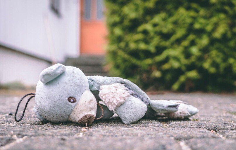 photo of bear plush toy on pavement