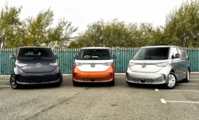 three electric vehicles parked in a parking lot