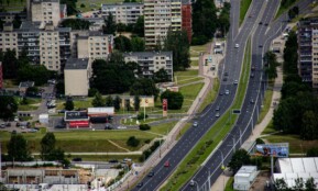 cars on road near high rise buildings during daytime